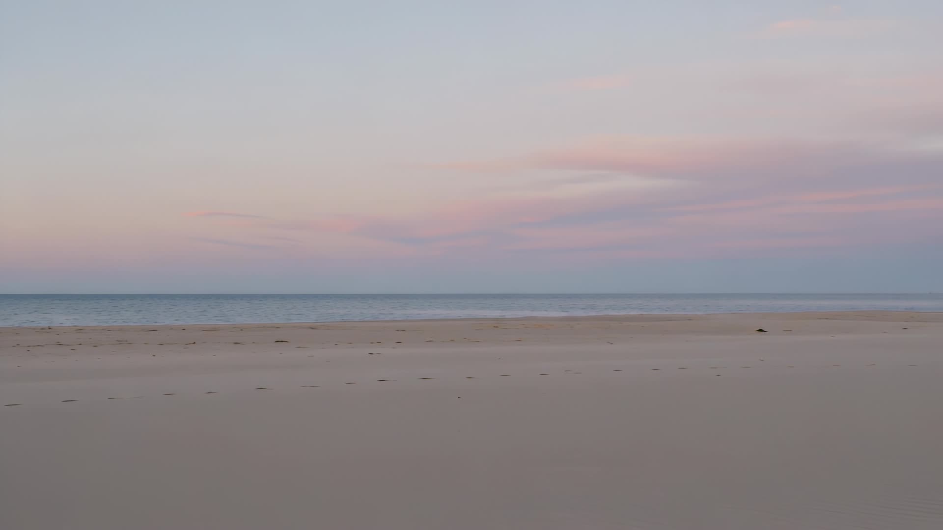 Empty beach at soft morning light, slow pan