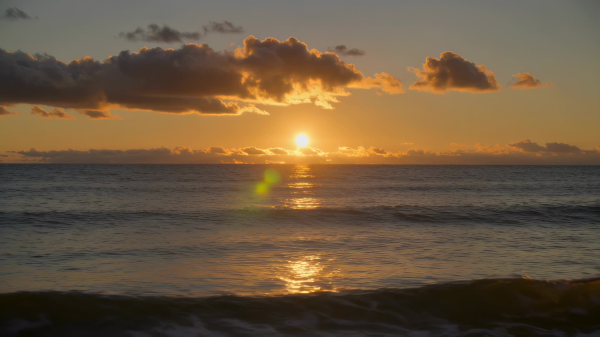 Sunset over calm ocean, static wide