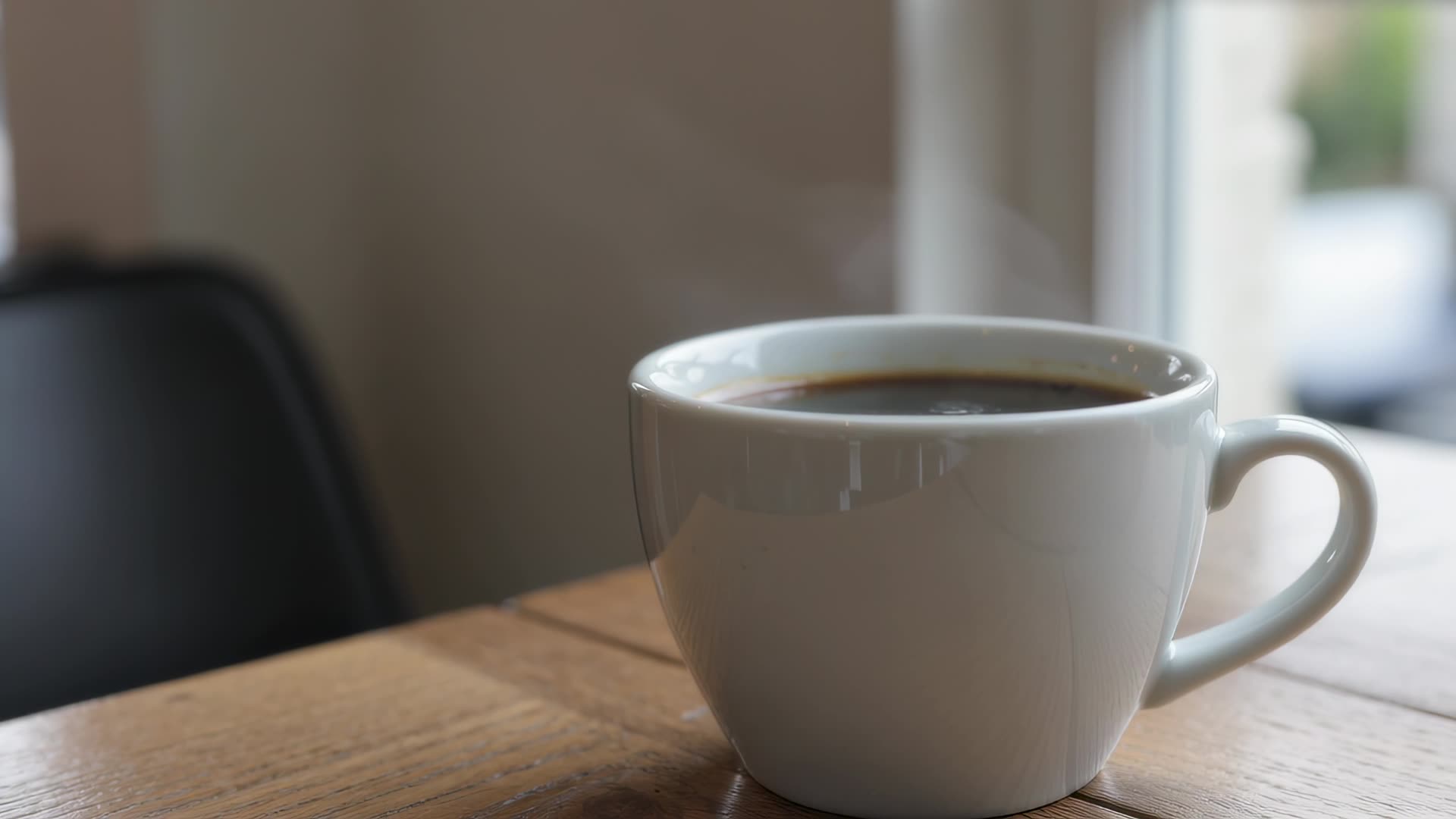 Steam rising from a cup by a window
