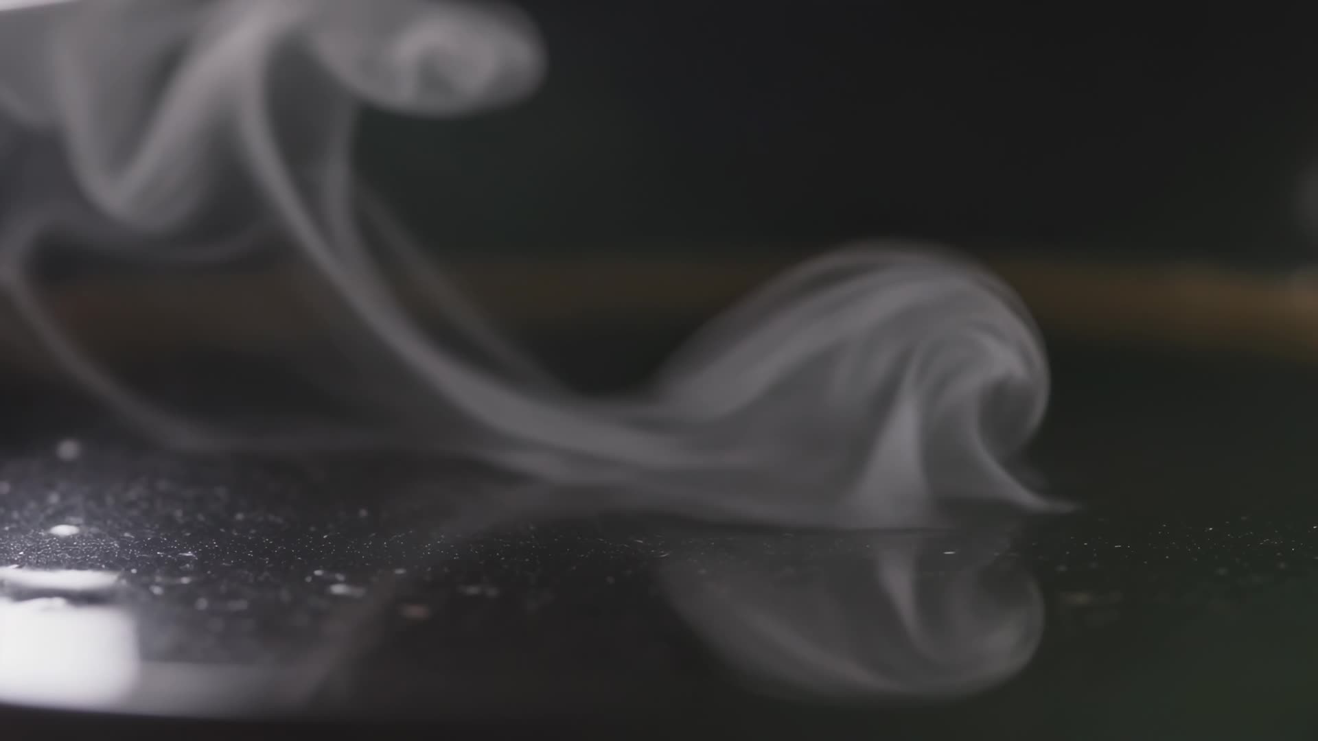 Steam curling off dark coffee, macro
