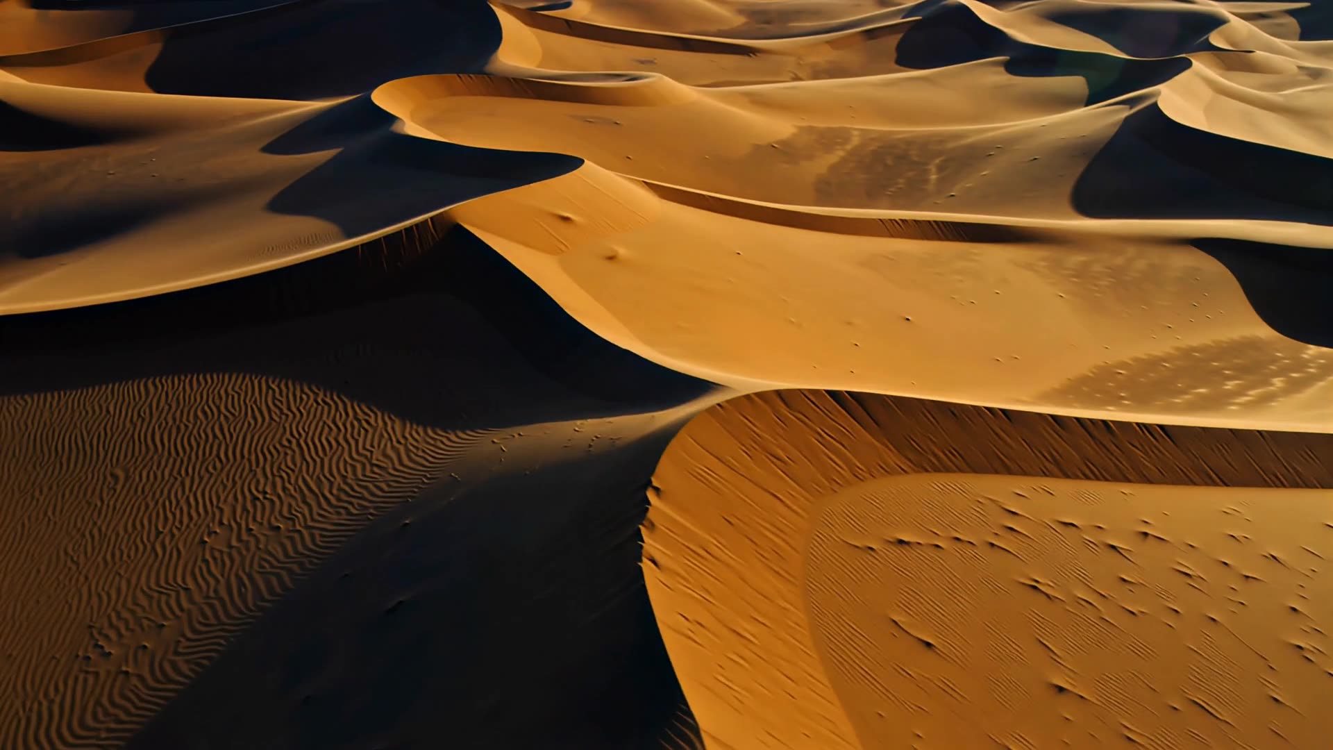 Aerial over dunes, long shadows