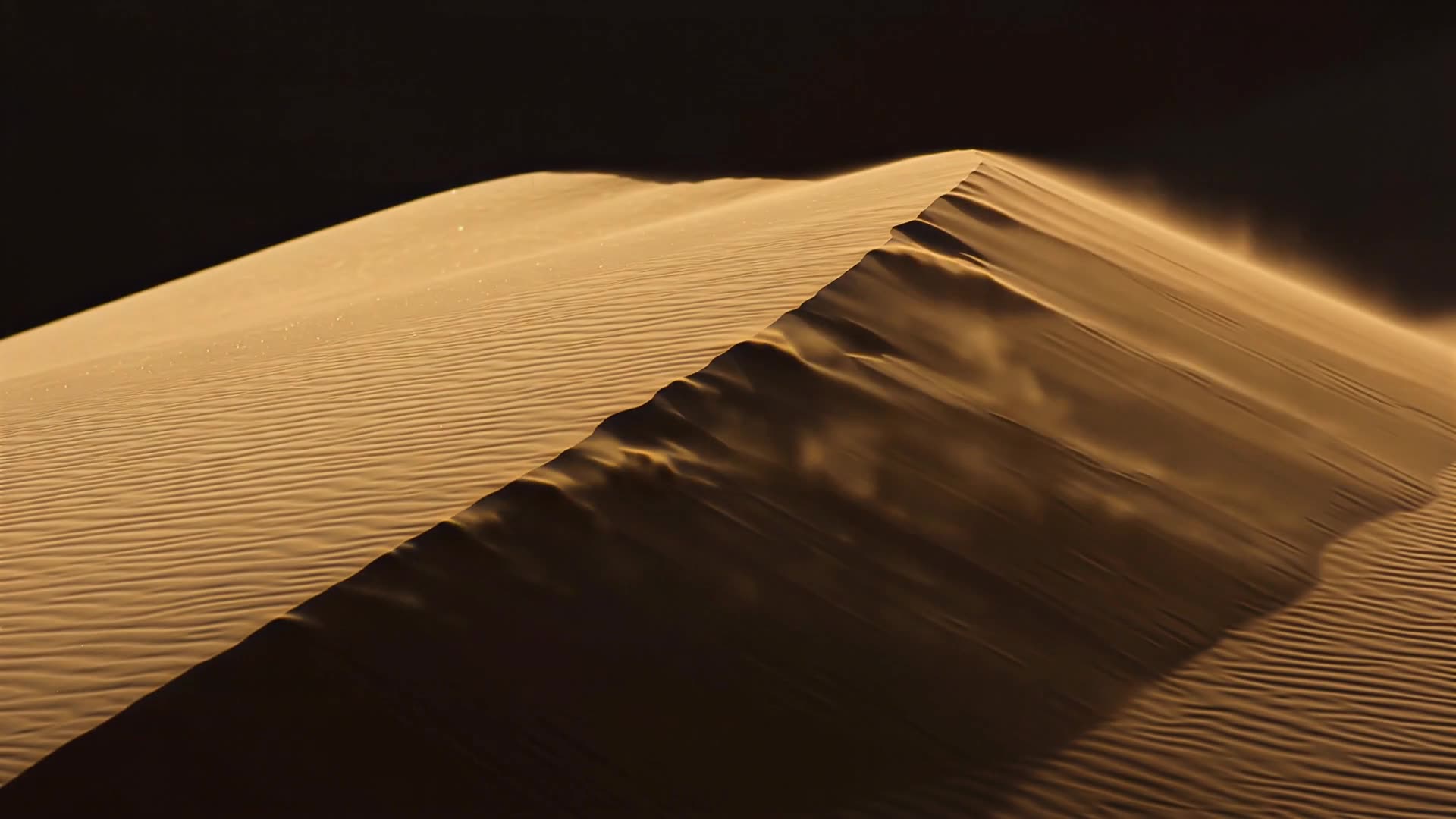 Wind lifting sand off a dune ridge