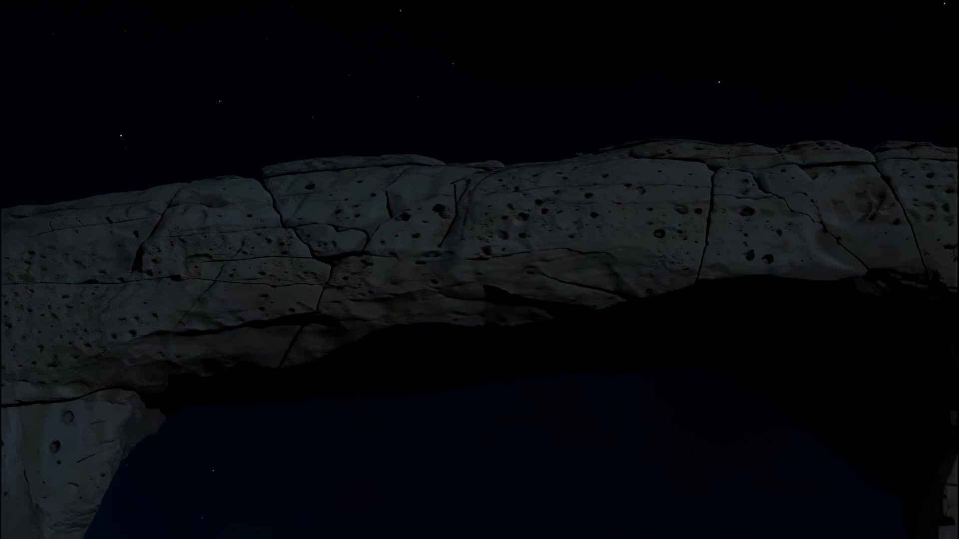 Rock arch against open sky (night)