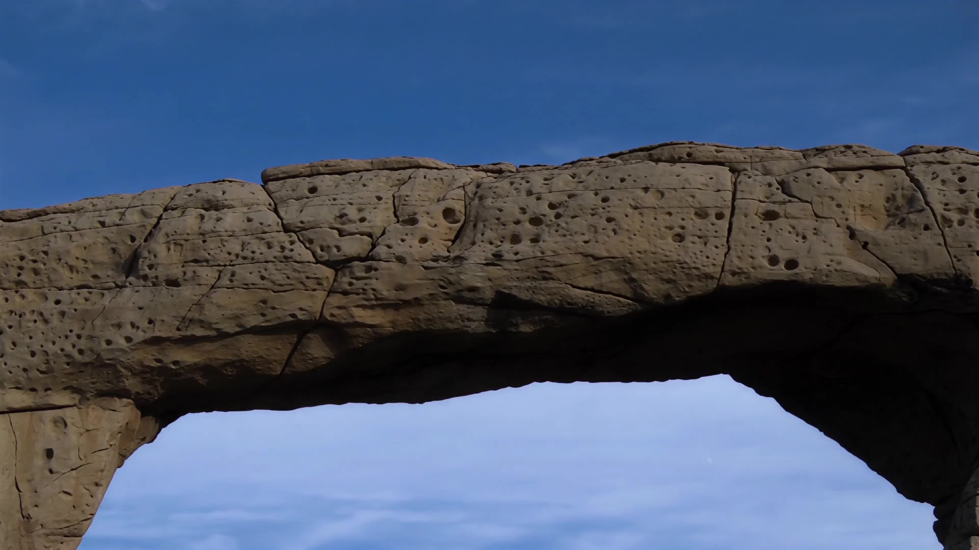 Rock arch against open sky