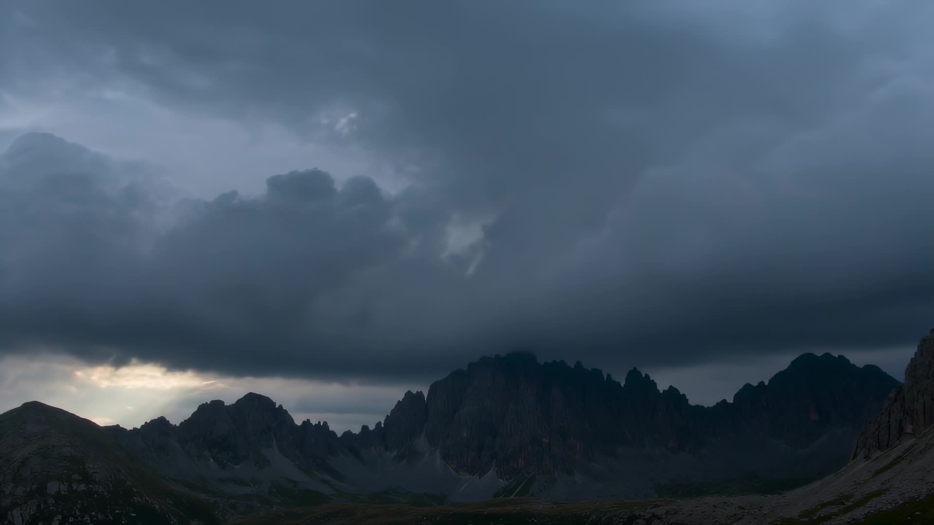 Storm clouds over dark peaks