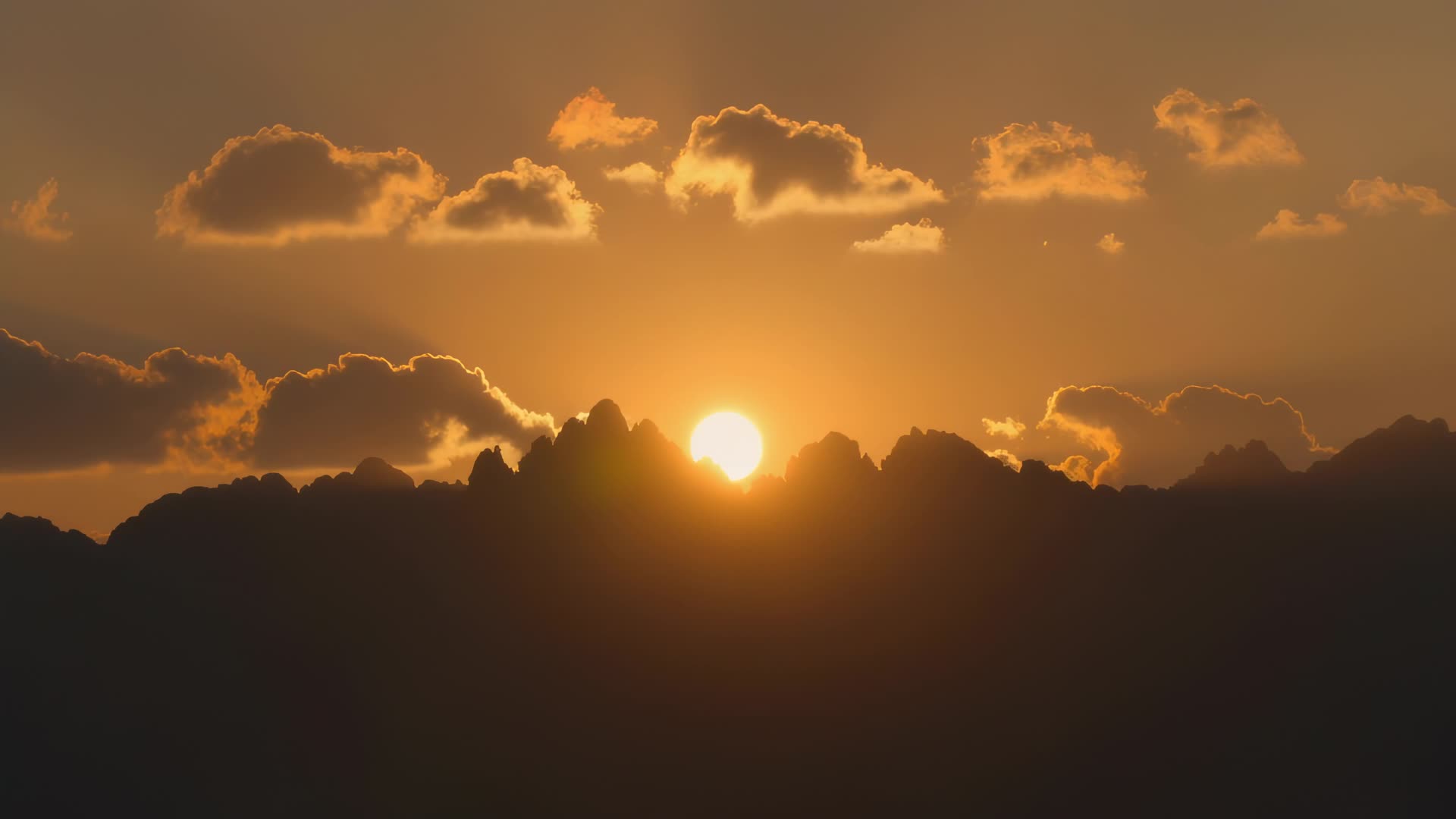 Sun setting behind ridgeline