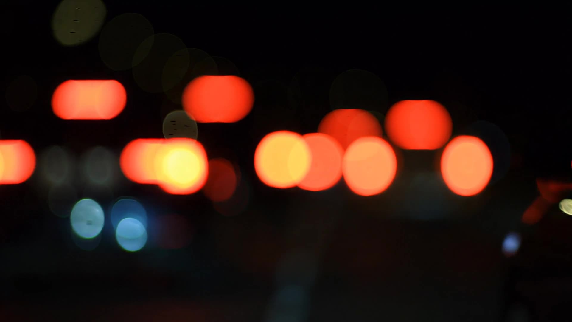 Red tail-light bokeh at night