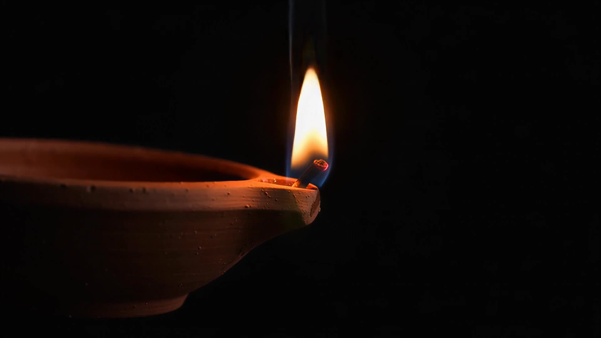 Single diya flame, close-up