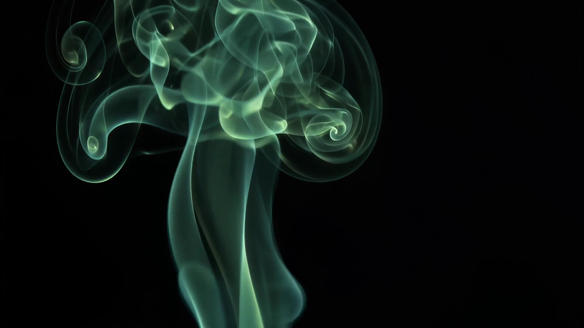 Smoke curling in green light