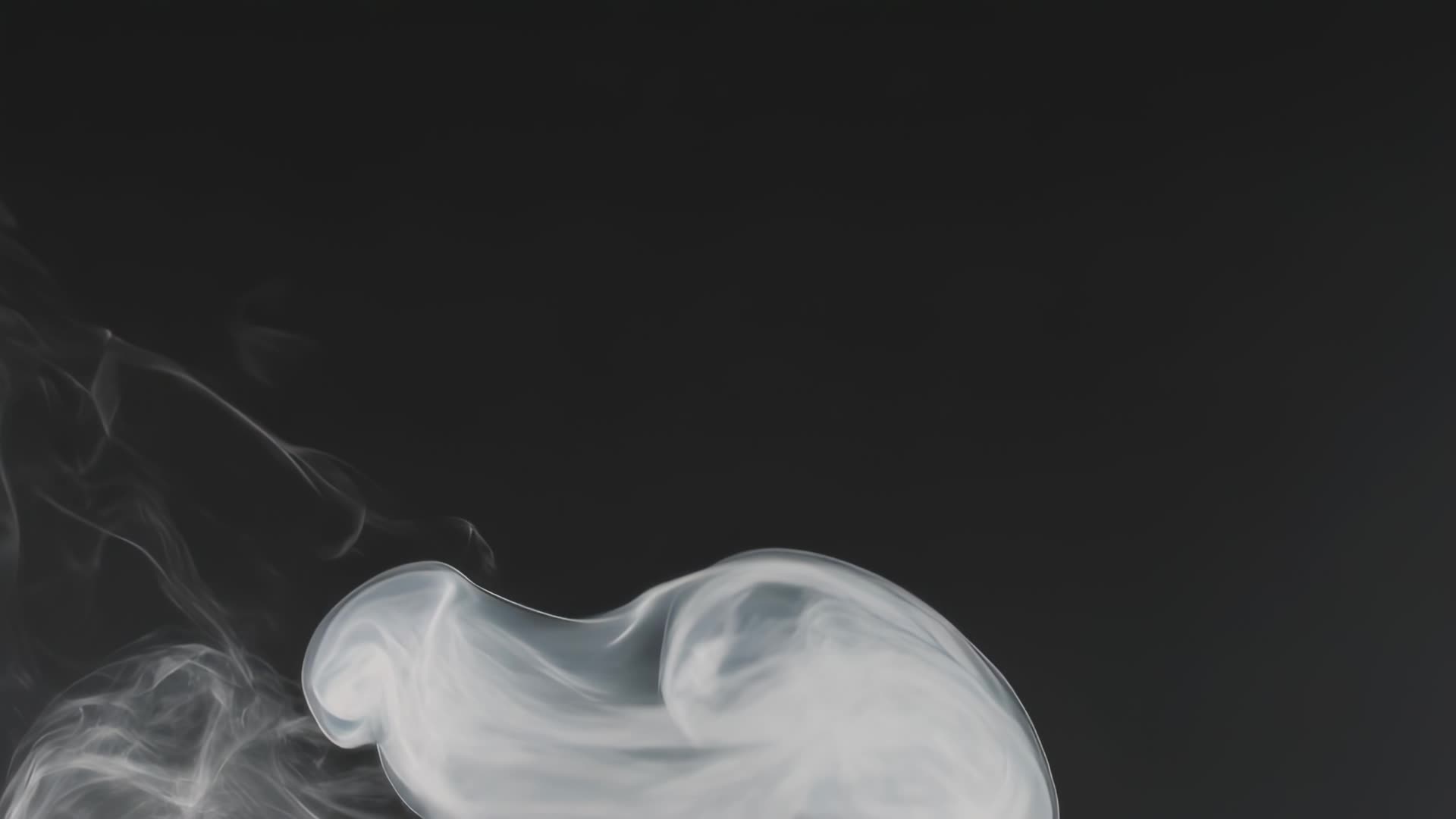 Smoke wisps curling on black