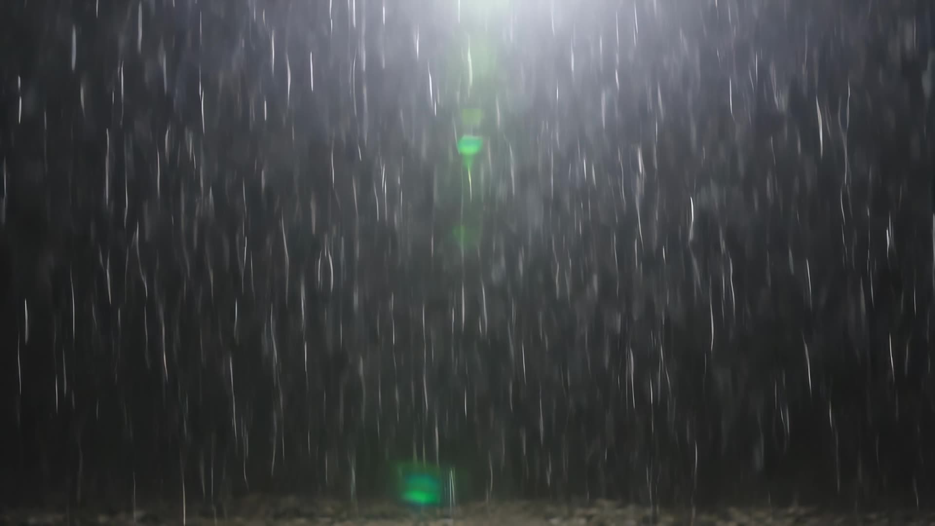 Heavy rain against dark background