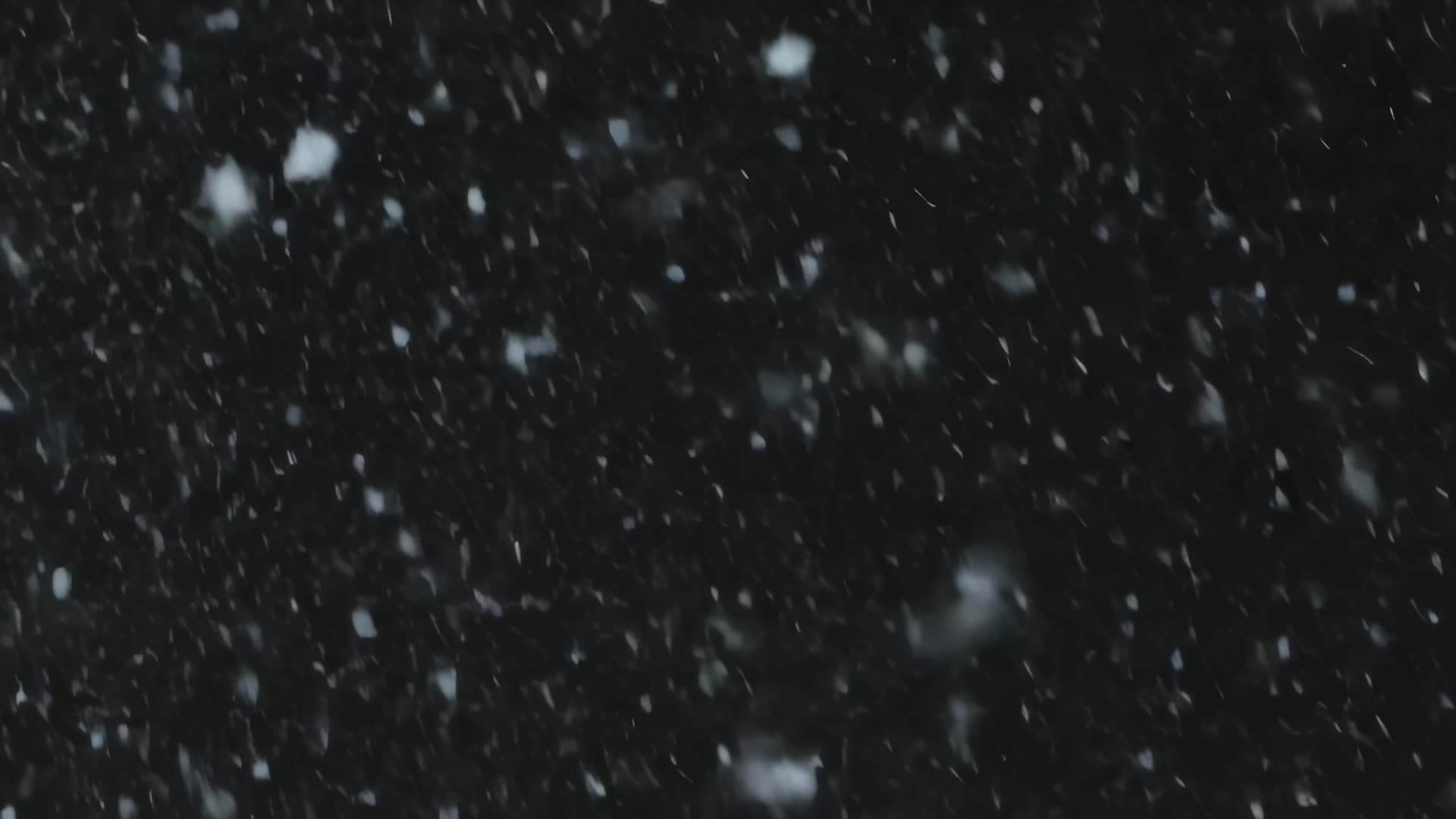 Dense snowfall on dark background